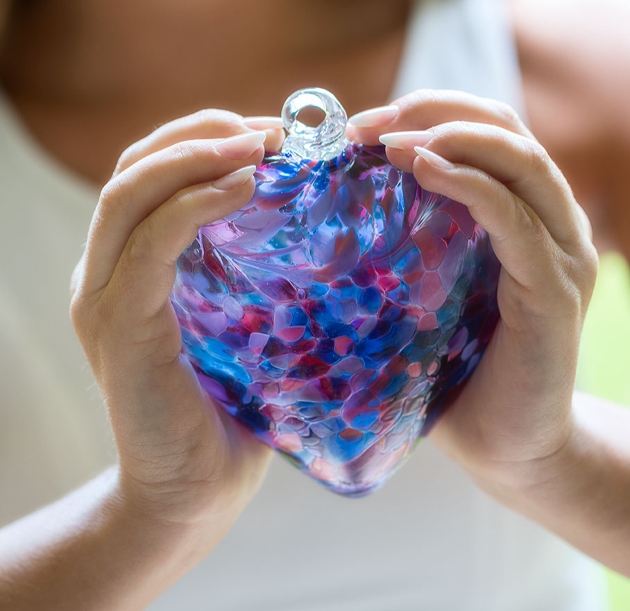 glass heart in hands