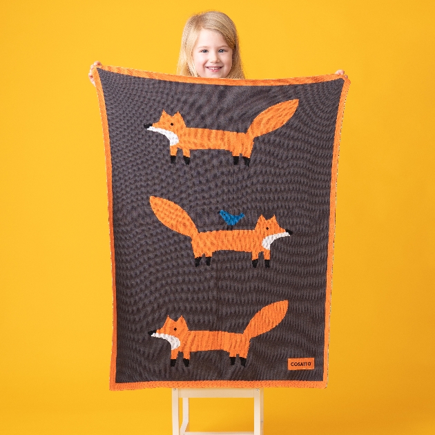 girl holding a fox blanket