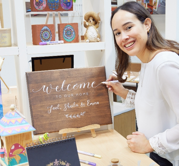 a girl painting a sign