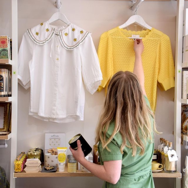 woman looking at clothes in a shop