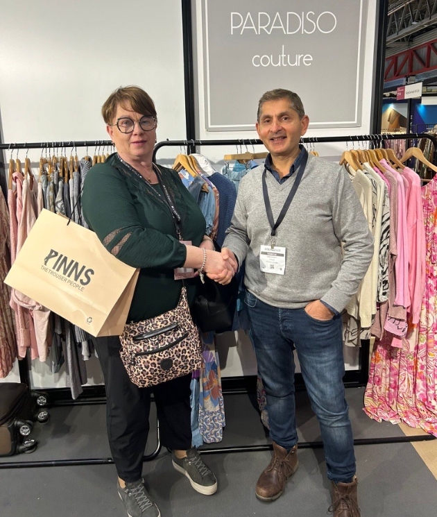 man and woman shaking hands at a trade show