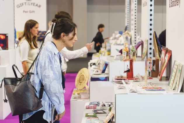 ladies looking at stands with giftware at a trade show